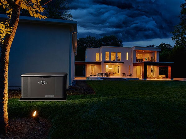 Generator outside of a modern home at night